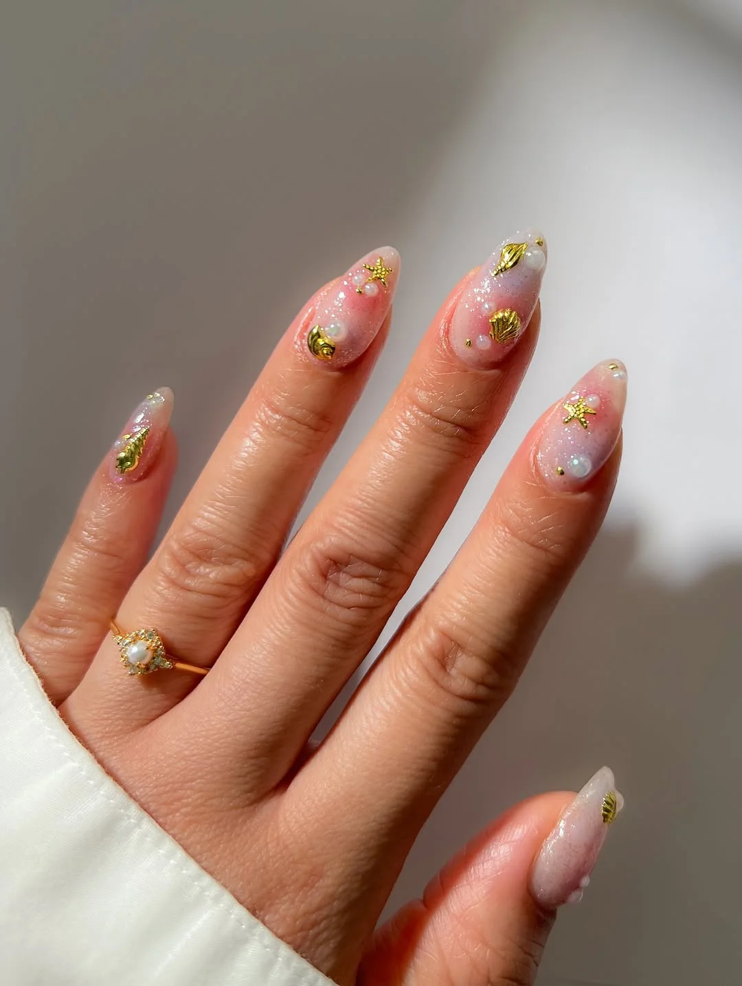 summer beach nails 2026 Pink Pearl Glow Nails With Gold Shell Accents