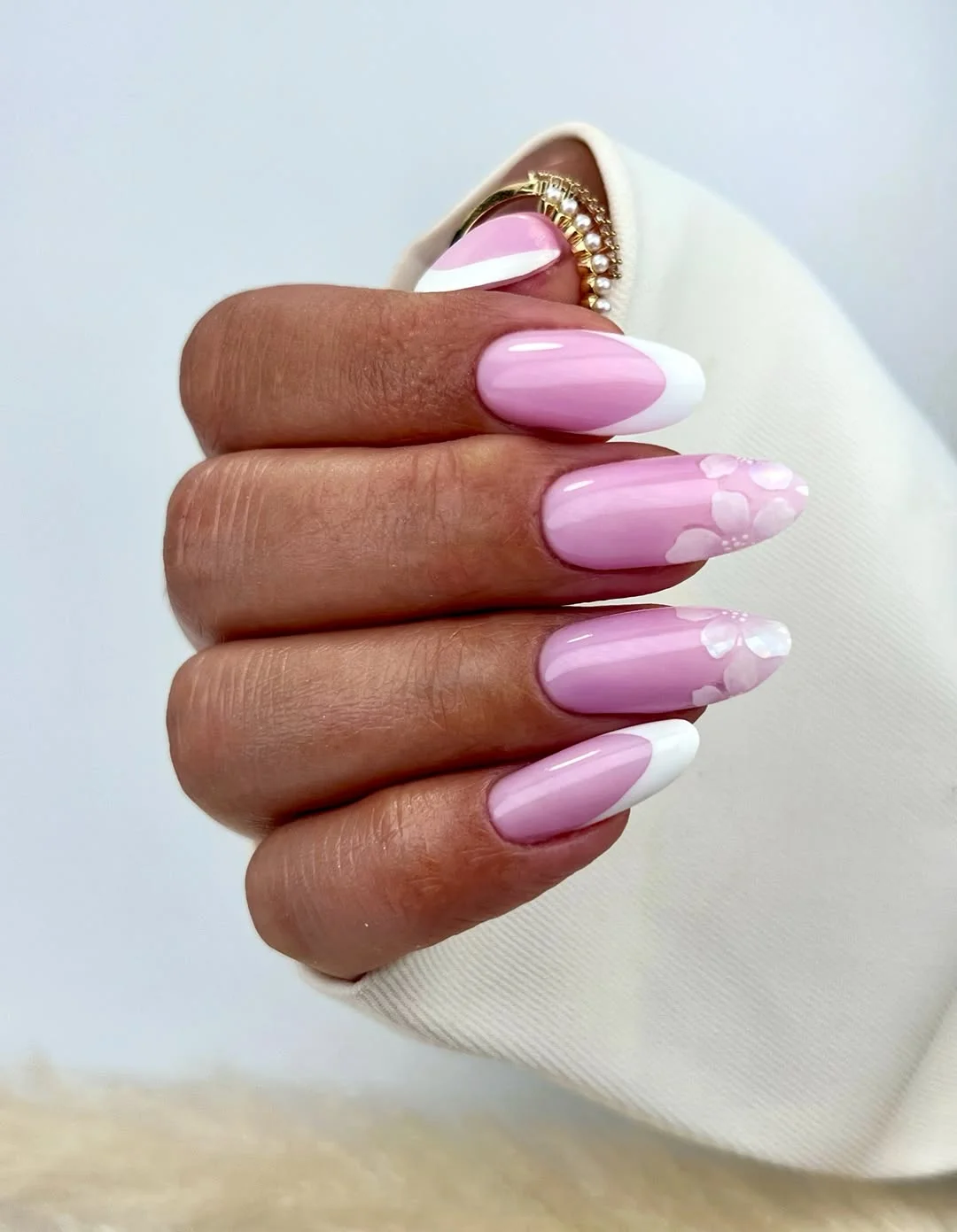 summer french nails ideas 2026 Soft Pink Almond French Tips With White Flowers