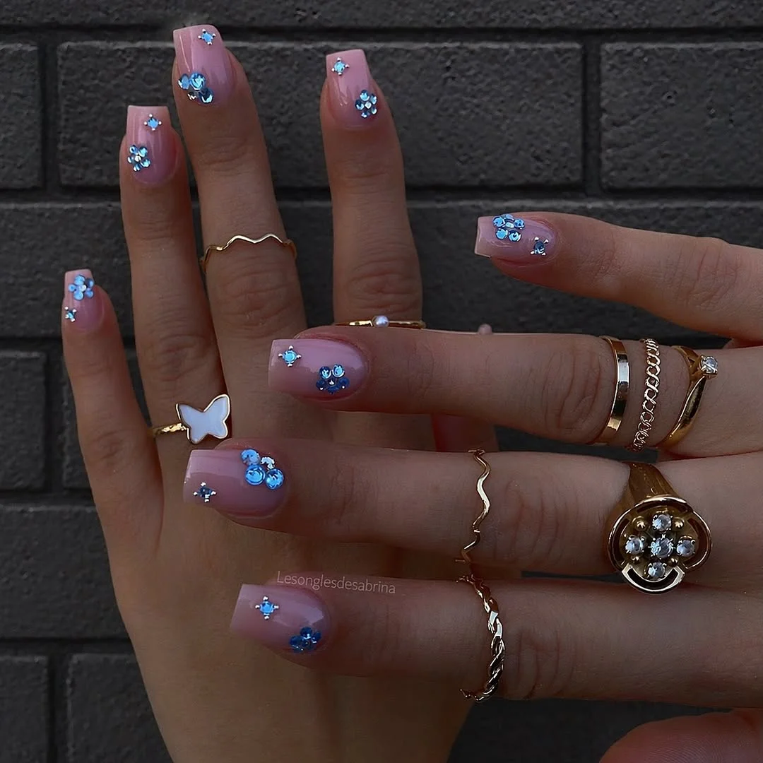 summer glitter nails 2026 Simple Nude Nails With Blue Crystal Flowers