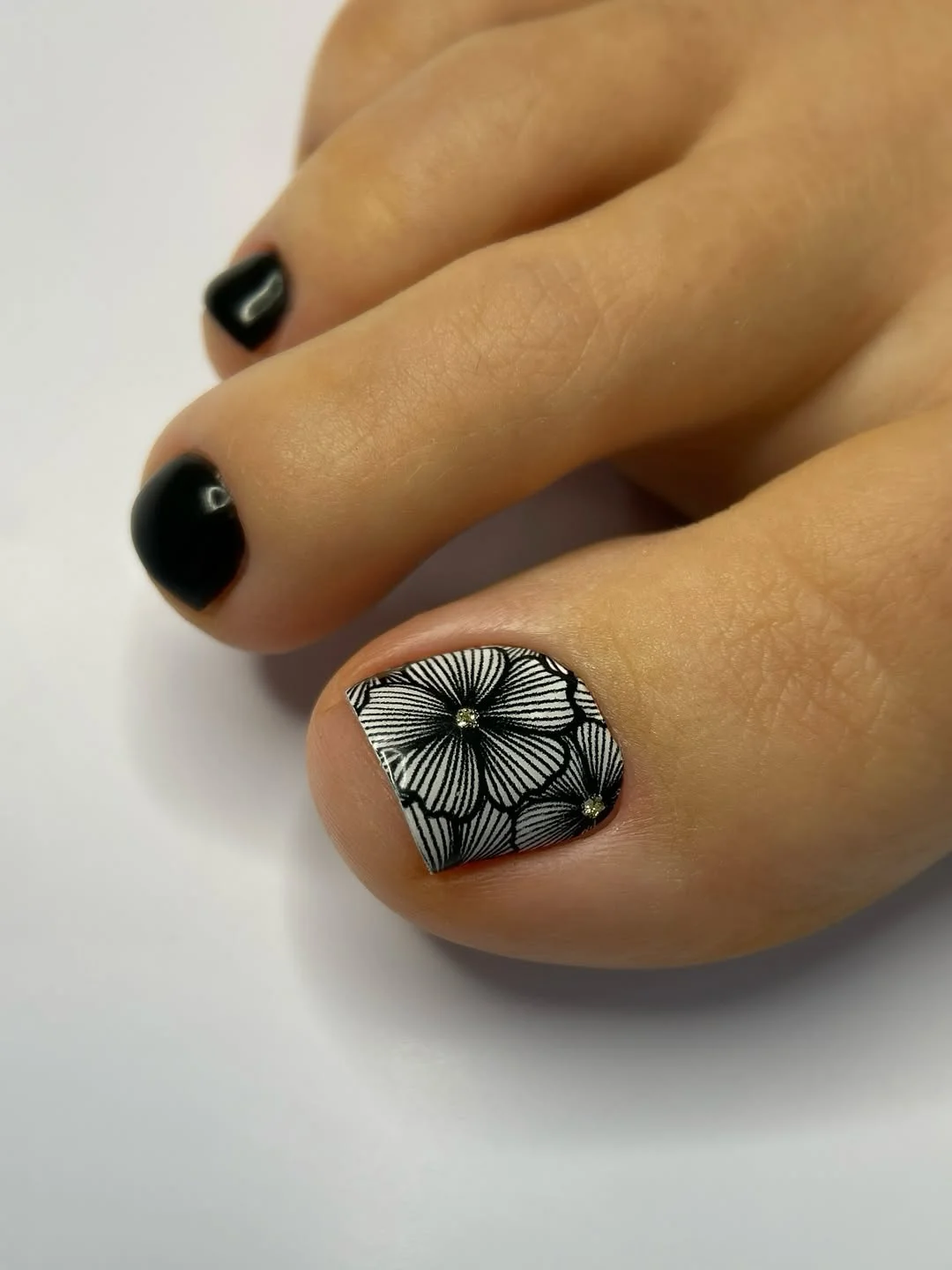 summer toe nails colors 2026 Black Floral Art Pedicure