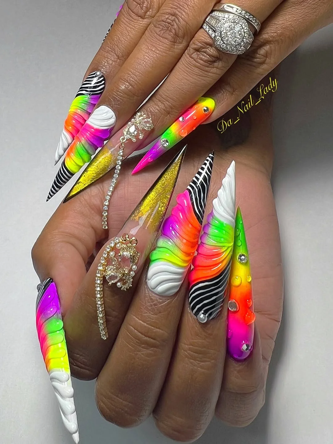 summer vibrant nails summer 2026 Neon Rainbow Stiletto Nails With Dramatic Texture