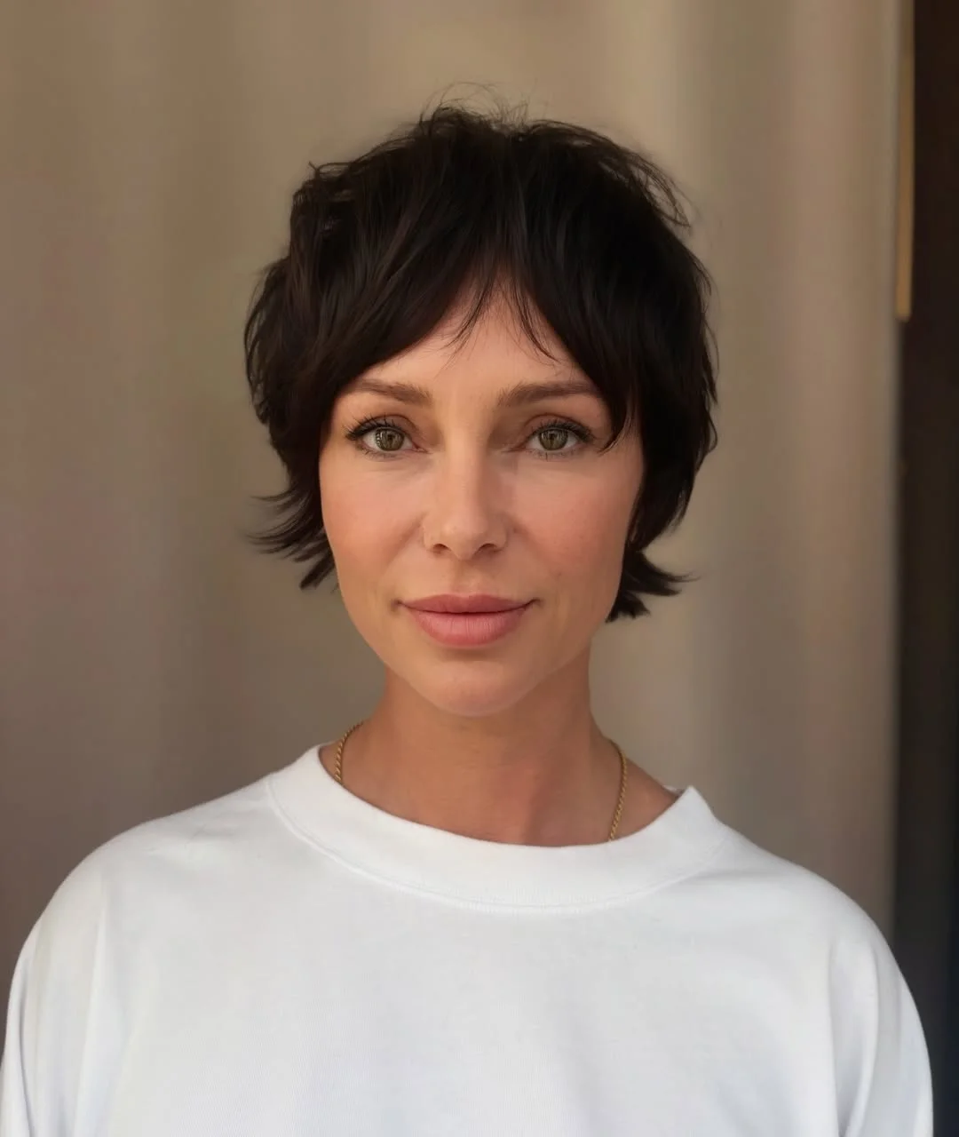 textured summer bixie haircut 2026 Feathered Brunette Bixie with Soft Bangs
