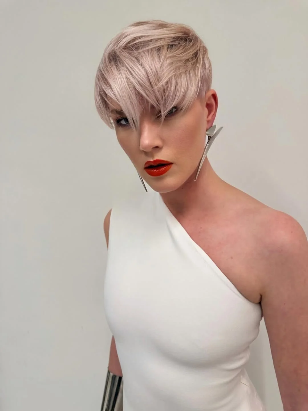 textured summer shag hairstyle 2026 Feathered Ice Blonde Pixie Shag Energy