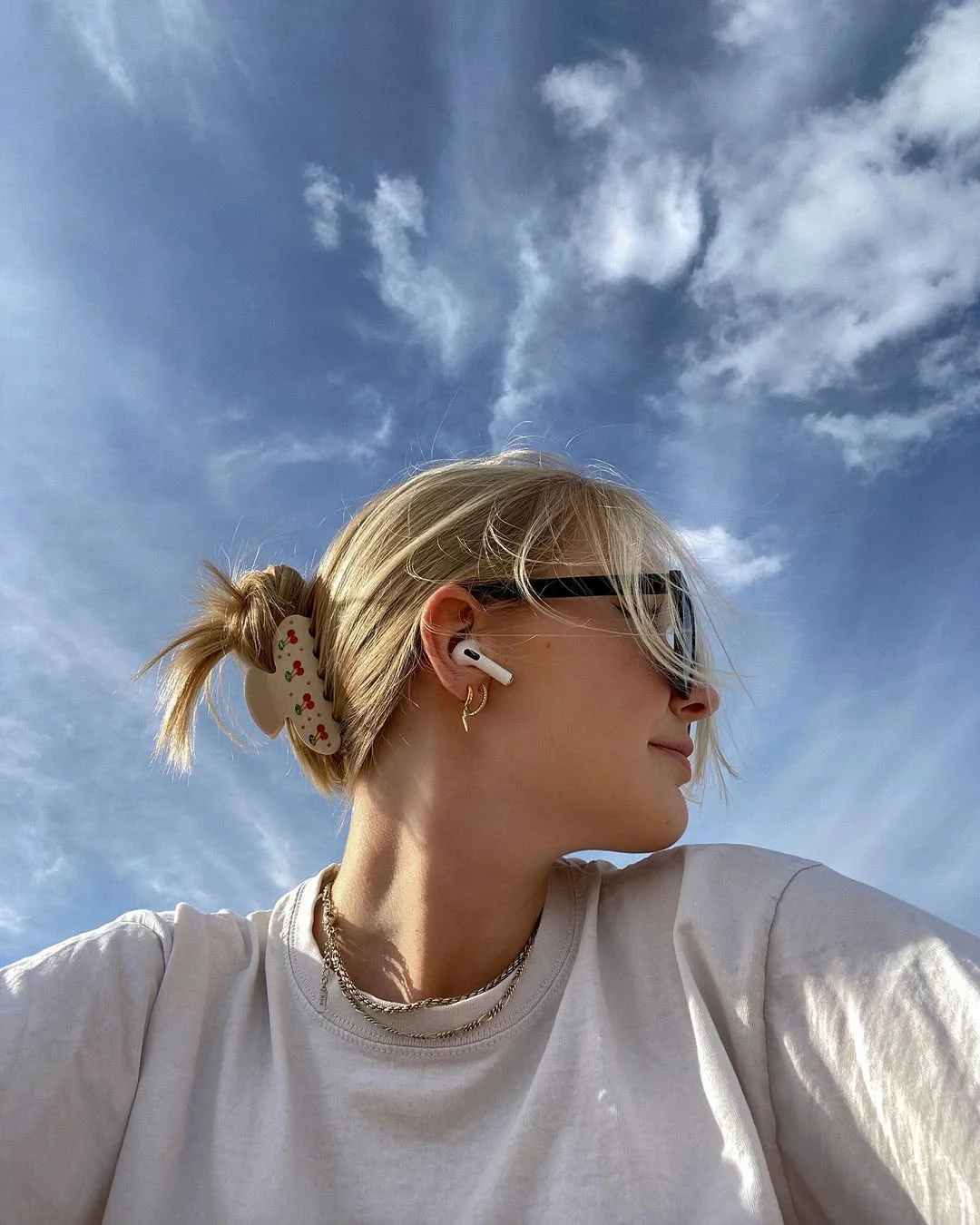 textured summer shag hairstyle 2026 Minimal blonde micro bun with undone texture