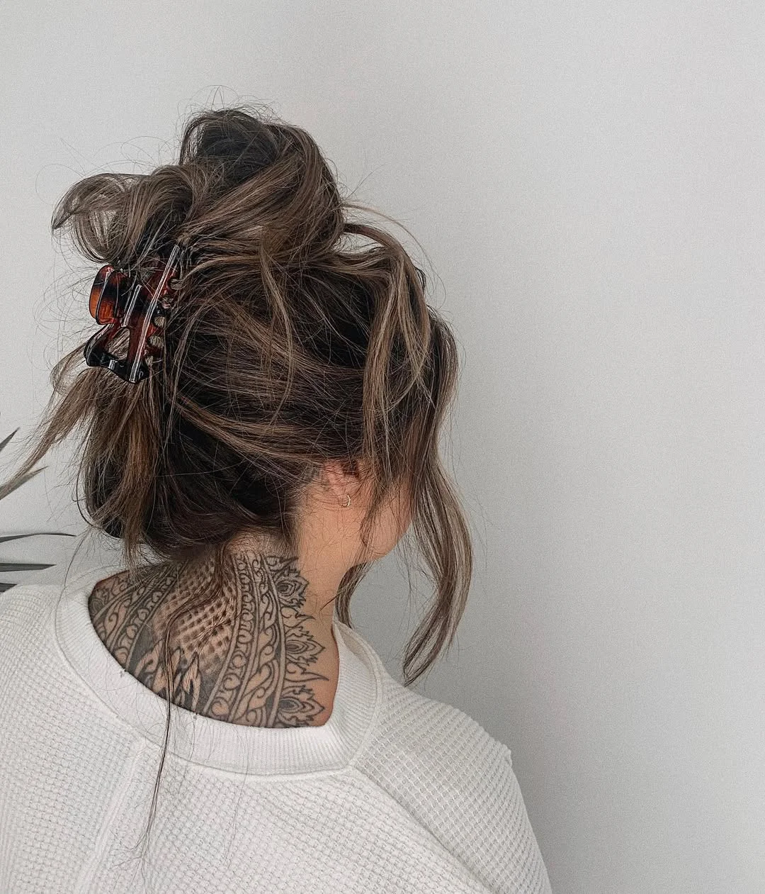 textured summer shag hairstyle 2026 Messy claw clip updo with soft shag layers