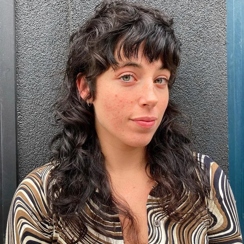 textured summer shag hairstyle 2026 Soft curly shag with micro fringe movement
