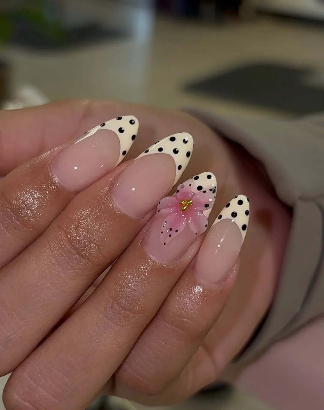 trendy summer nails 2026 Polka Dot French Tips With Pink Floral Accent