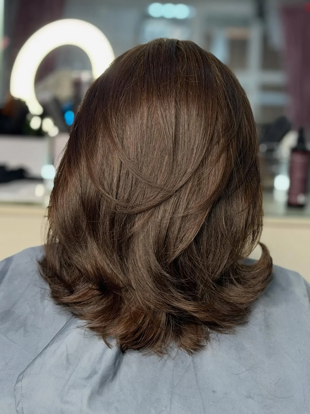 youthful summer haircuts for women over 50 2026 Layered Medium Cut With Airy Movement