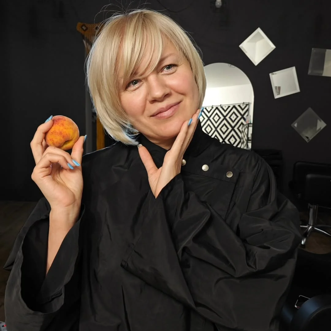 youthful summer haircuts for women over 50 2026 Chin-Length Blonde Bob with Side Bangs