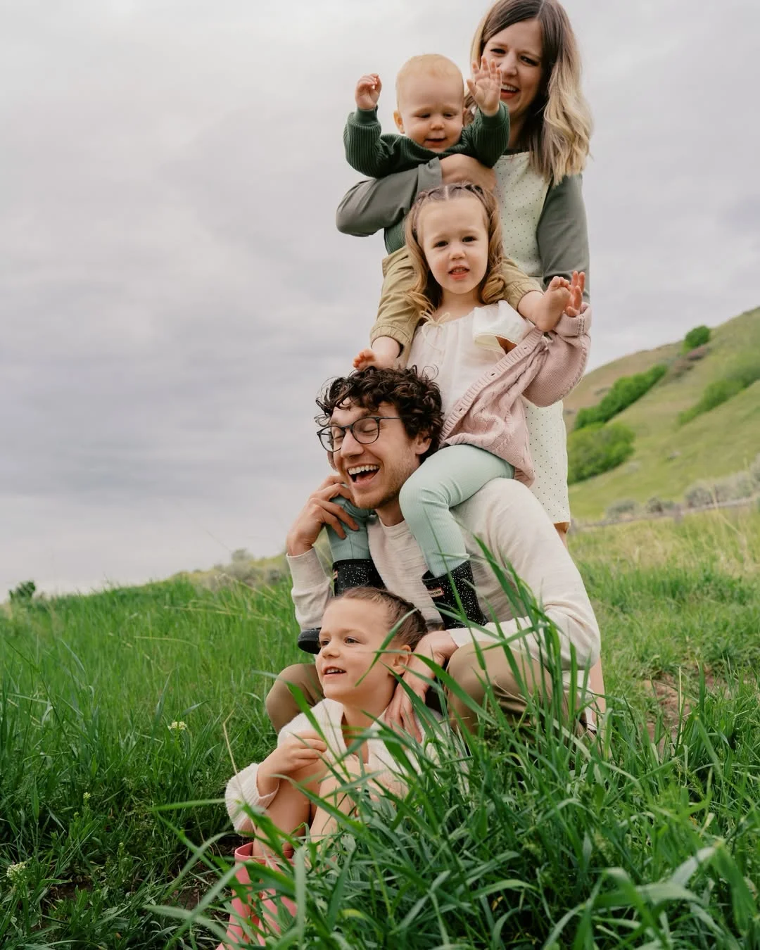 fall family picture outfits 2026 Neutral Tones And Green For Playful Family Moments