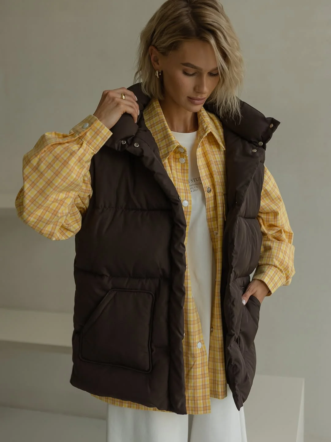 fall outfits with vests 2026 Brown Puffer Vest With Warm Plaid Layers