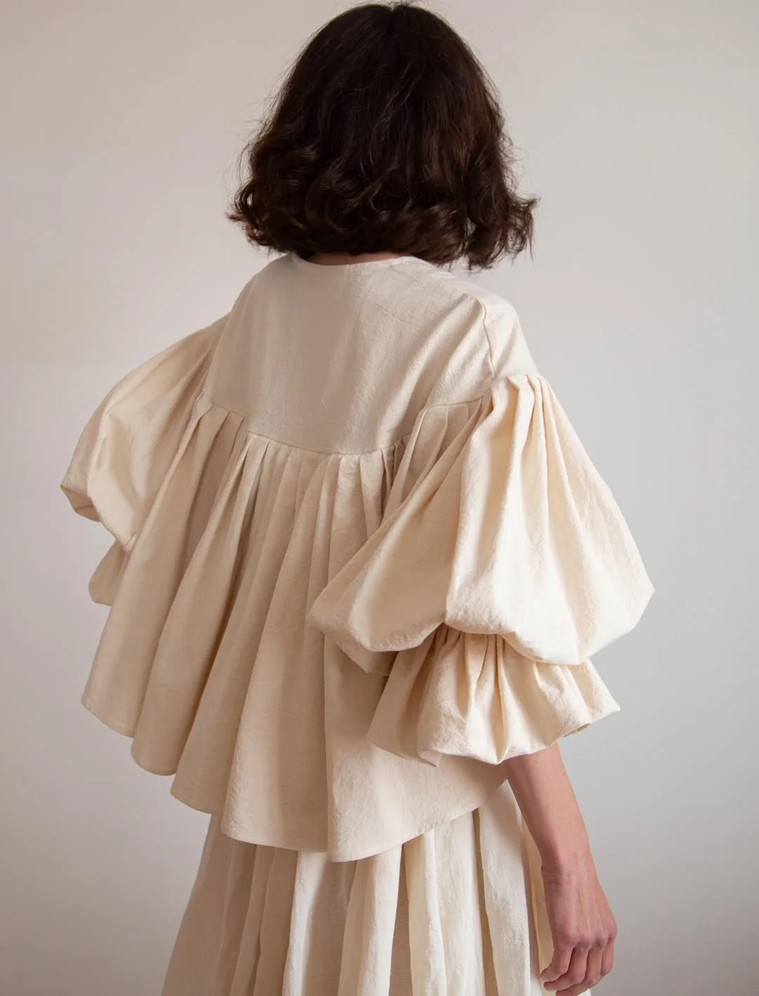july fashion trends 2026 Romantic Volume in Soft Neutral Shades