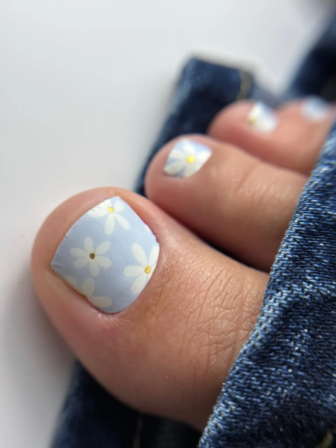 summer toe nails design ideas 2026 Soft Blue Daisy Pedicure