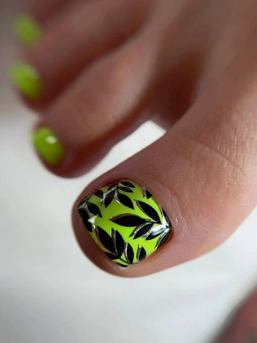 summer toe nails design ideas 2026 Neon Tropical Leaf Pedicure