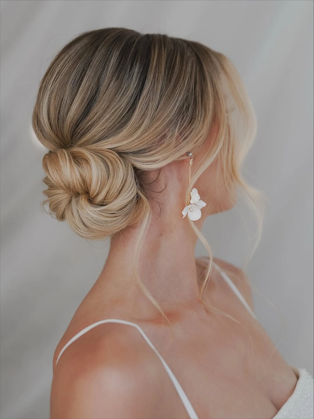 bridesmaid hairstyling Classic Low Chignon With Soft Blonde Dimension