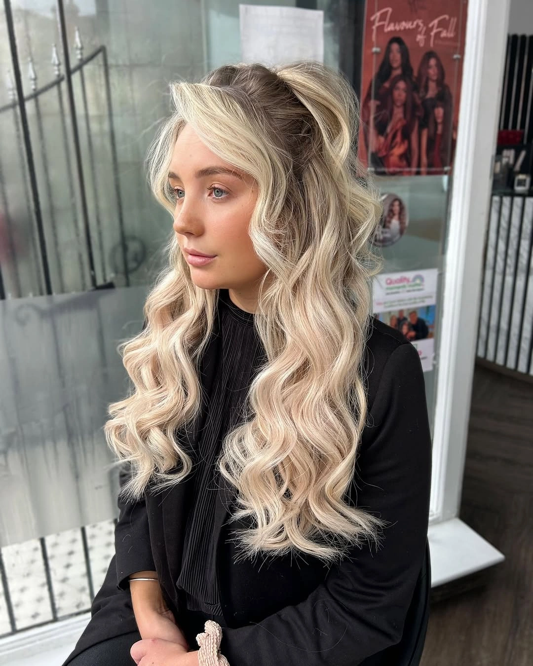 bridesmaid hairstyling Voluminous Half Up Curls With Bright Blonde Highlights
