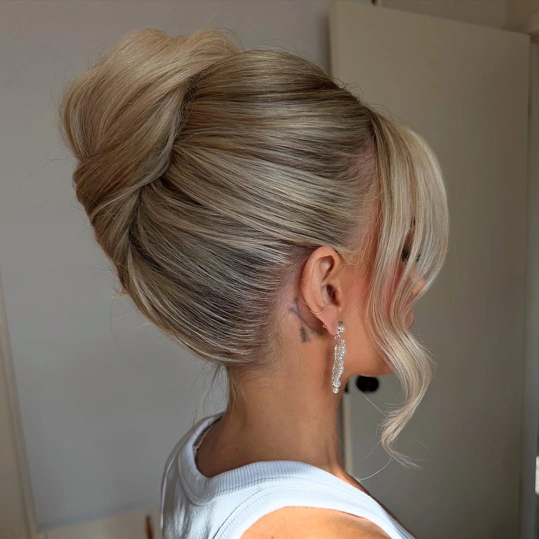 bridesmaid hairstyling Classic Sleek Low Bun With Curtain Bangs