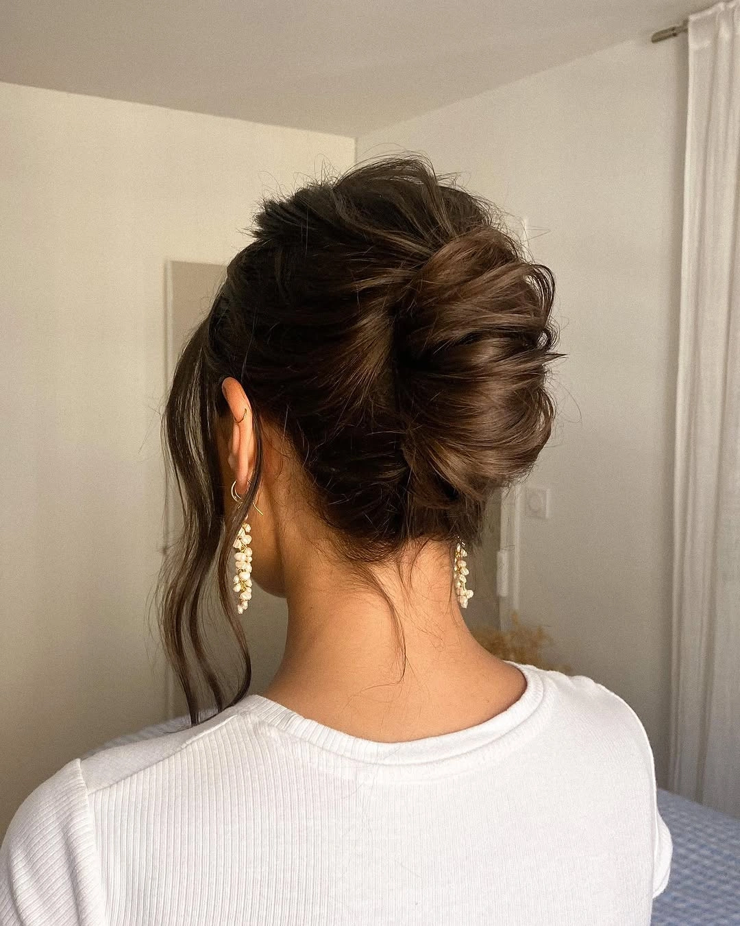 bridesmaid hairstyling Voluminous Twisted Bun For Brunette Hair