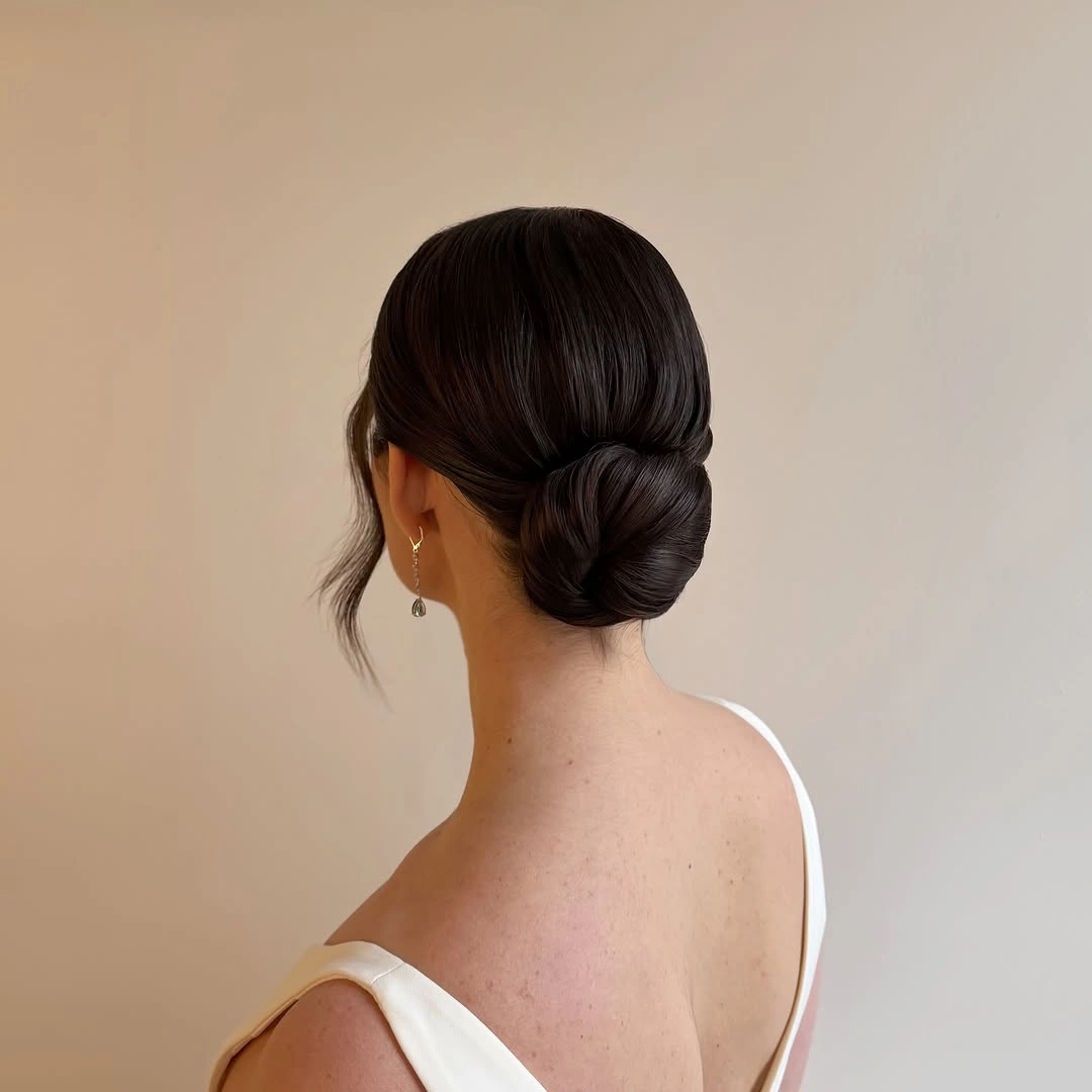 fall hairstyles for office 2026 Low Elegant Chignon With Soft Side Pieces