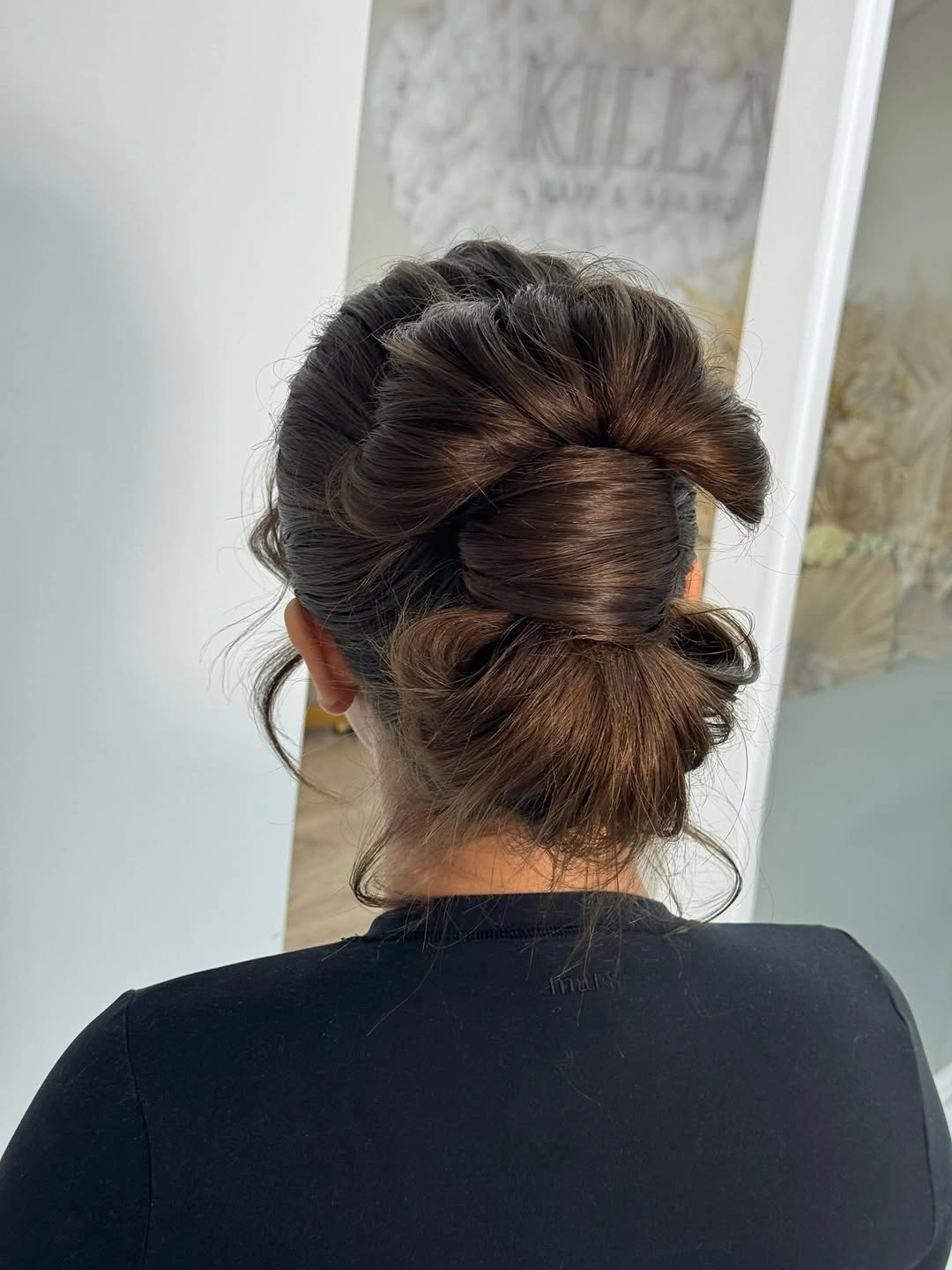 fall hairstyles for wedding guests 2026 Elegant Wrapped Low Bun With Soft Volume