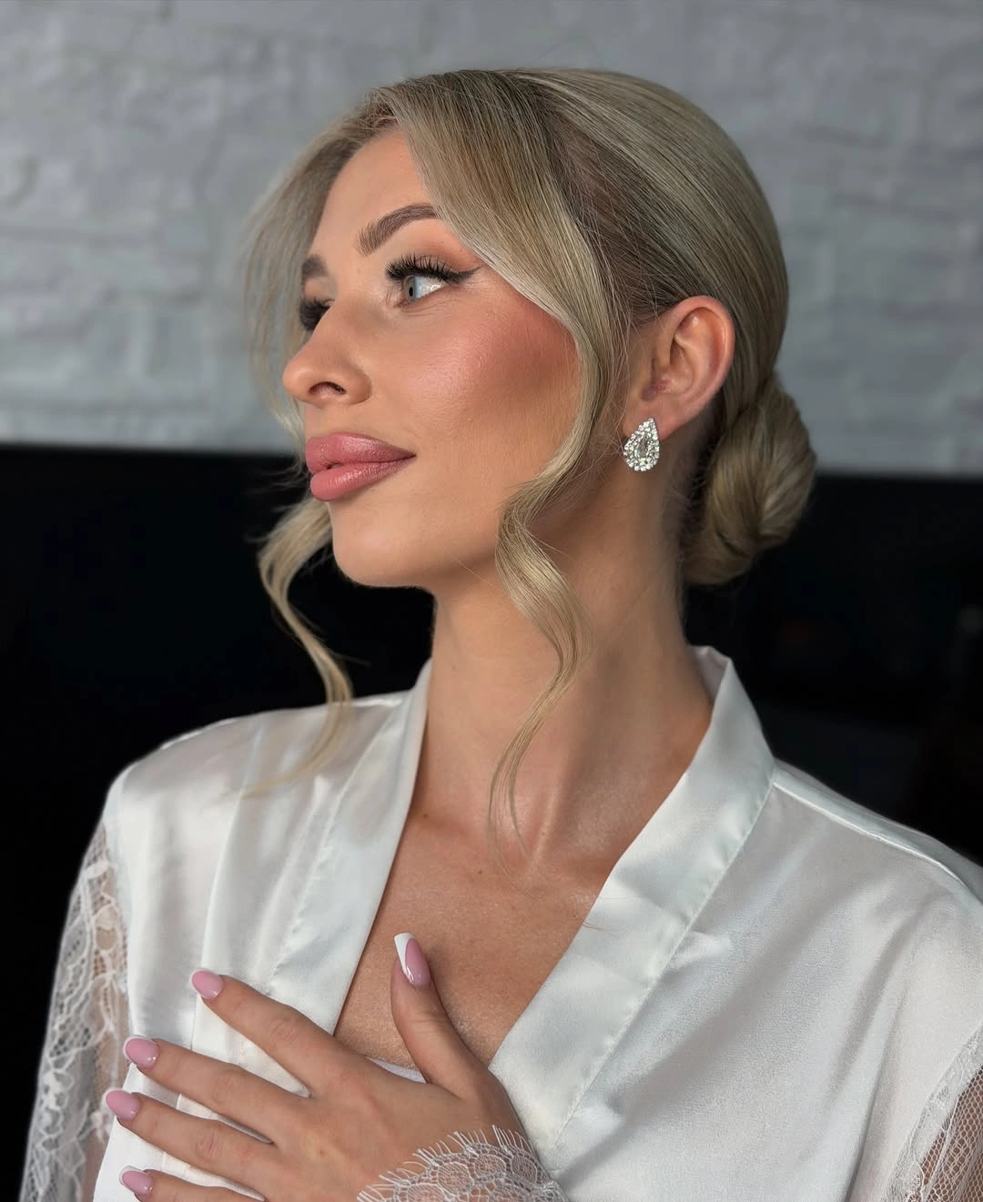 fall hairstyles for wedding guests 2026 Classic Low Bun With Face Framing Waves