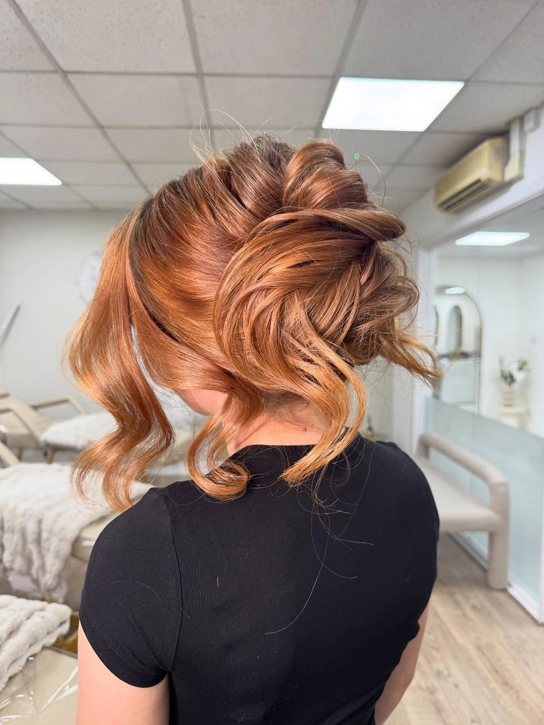 fall hairstyles for wedding guests 2026 Romantic Textured Copper Updo