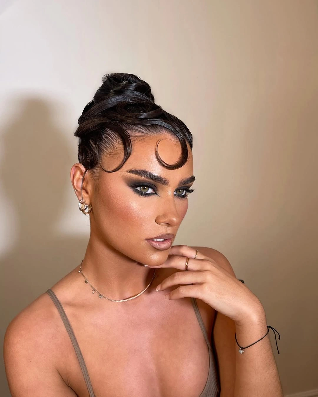 fall hairstyles for wedding guests 2026 Sleek Editorial Updo With Sculpted Tendrils