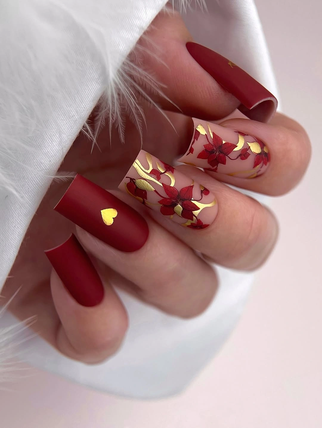 fall manicure 2026 Matte Crimson Nails With Golden Floral Details