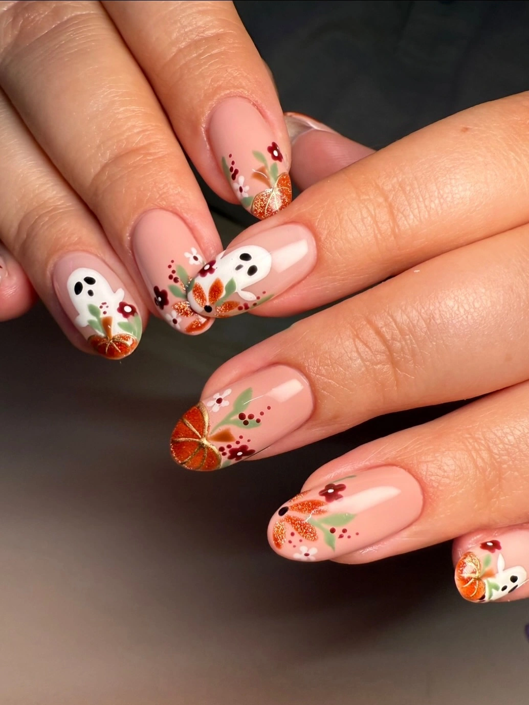 fall medium nail ideas 2026 Soft Nude Ghost and Pumpkin Nail Art