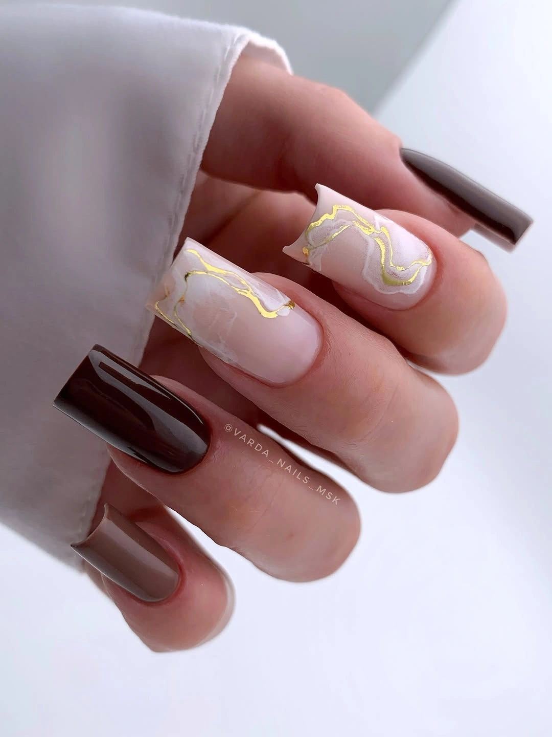 fall nail art 2026 Chocolate Marble Nails with Modern Gold Veins