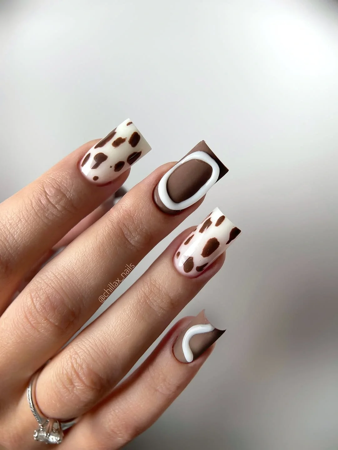 trendy nail colors for august 2026 Chocolate Cow Print Statement Nails