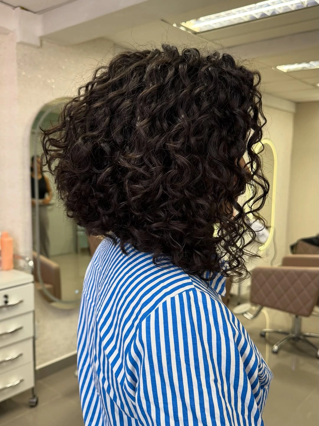 curly bob haircut Glossy Layered Bob With Defined Curls