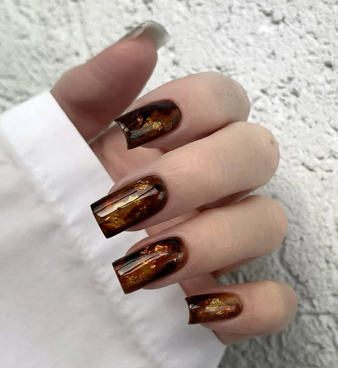 dark fall nails 2026 chocolate tortoiseshell gold foil manicure