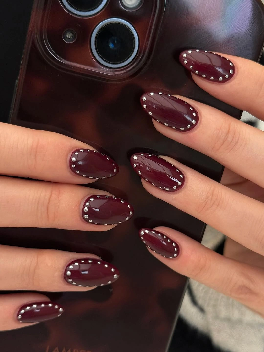 fall burgundy nails with design Glossy Burgundy Nails With Silver Stud Borders