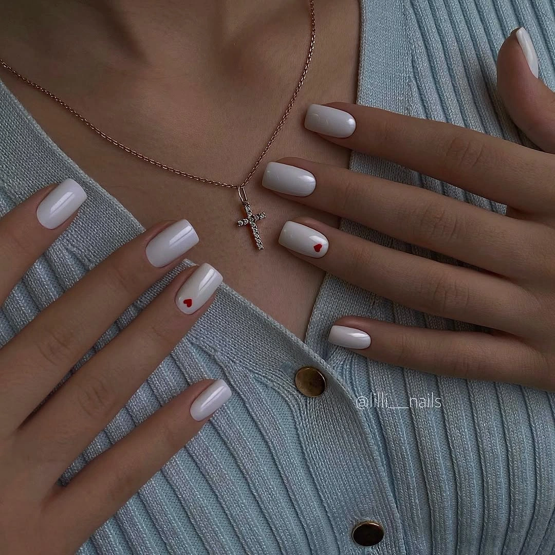 Fall gel nails ideas 2026 Milky White Nails With Tiny Red Hearts