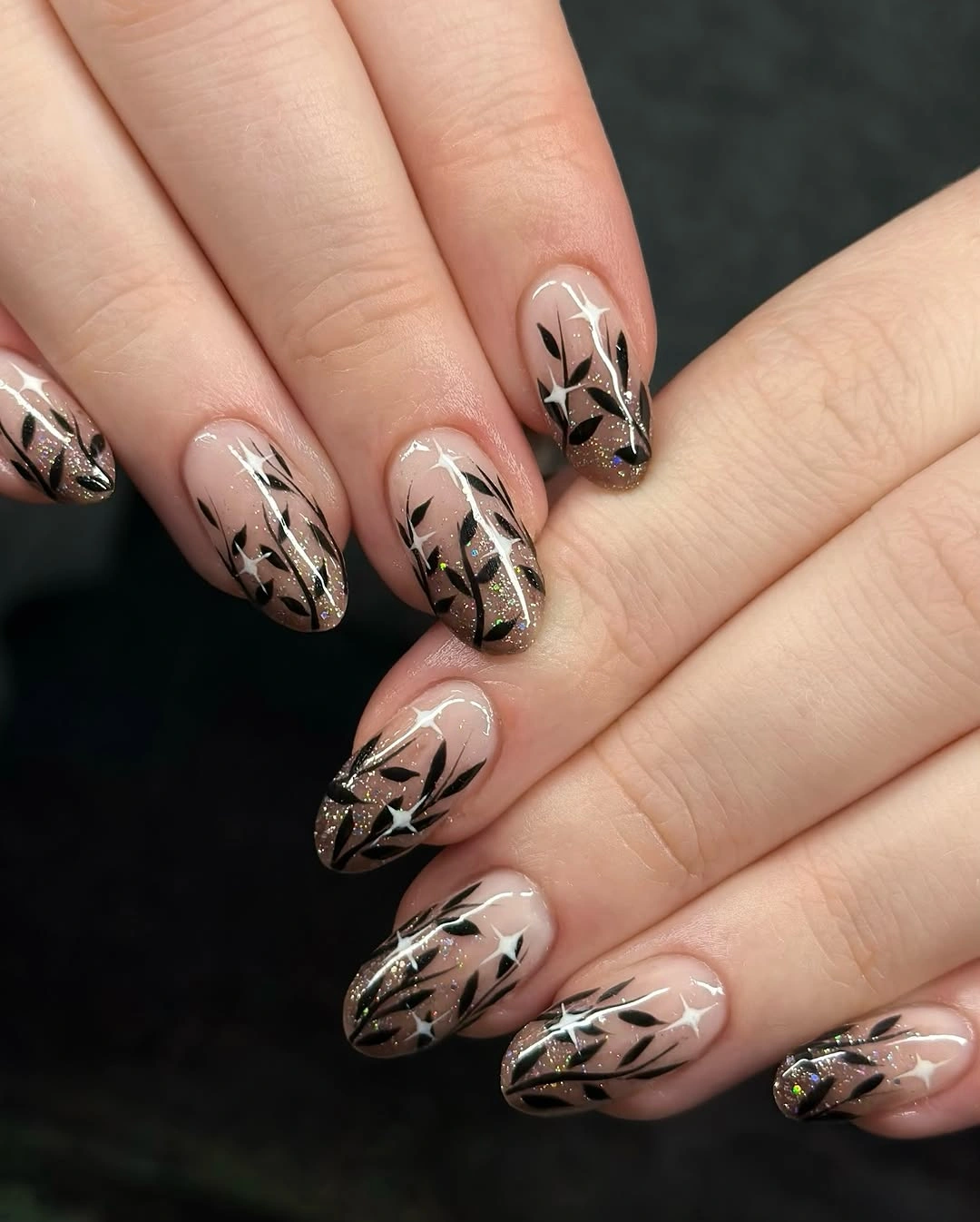 fall nail art ideas 2026 Black Botanical Nails With Stardust