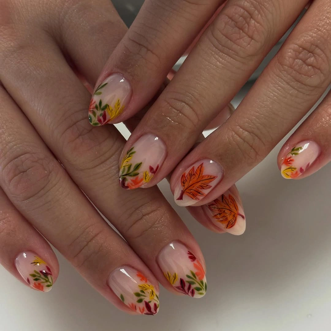 fall nail trends 2026 Delicate Botanical Nails With Autumn Leaves