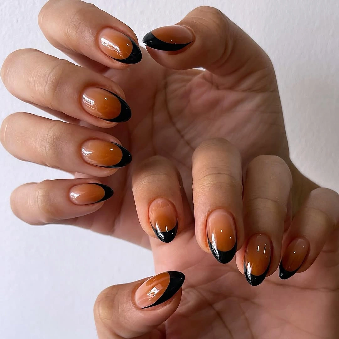 fall nail trends 2026 Black French Tips With Amber Glow