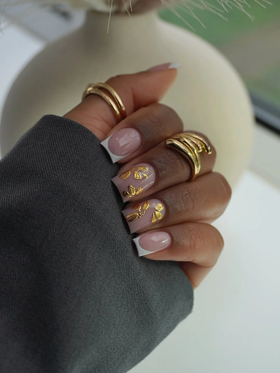 fall nails for dark skin 2026 French Tips With Golden Botanical Accents