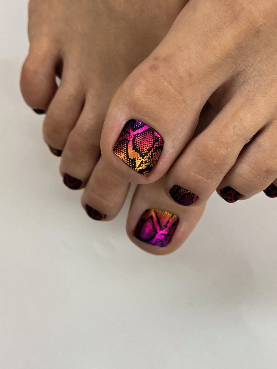 fall toe nails colors 2026 Magenta And Copper Snakeskin Pedicure