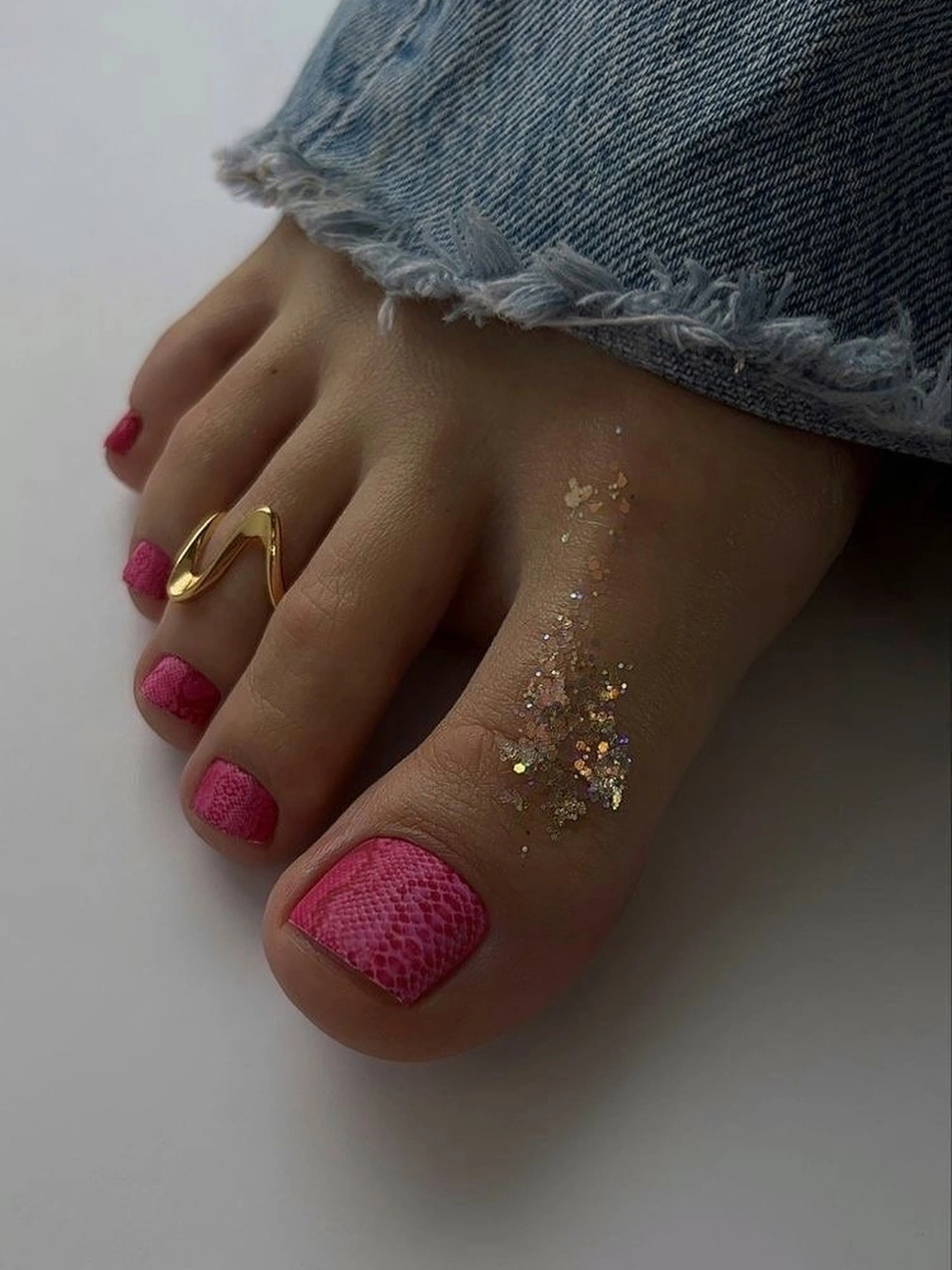 fall toe nails colors 2026 Pink Textured Snake Print Pedicure