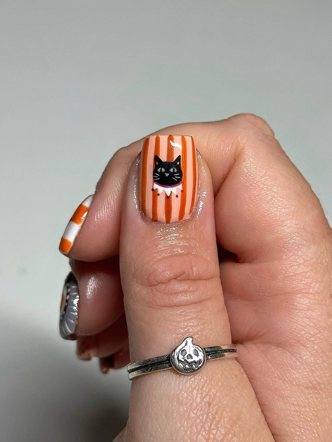 halloween nail art 2026 Orange Stripes and Tiny Black Cat