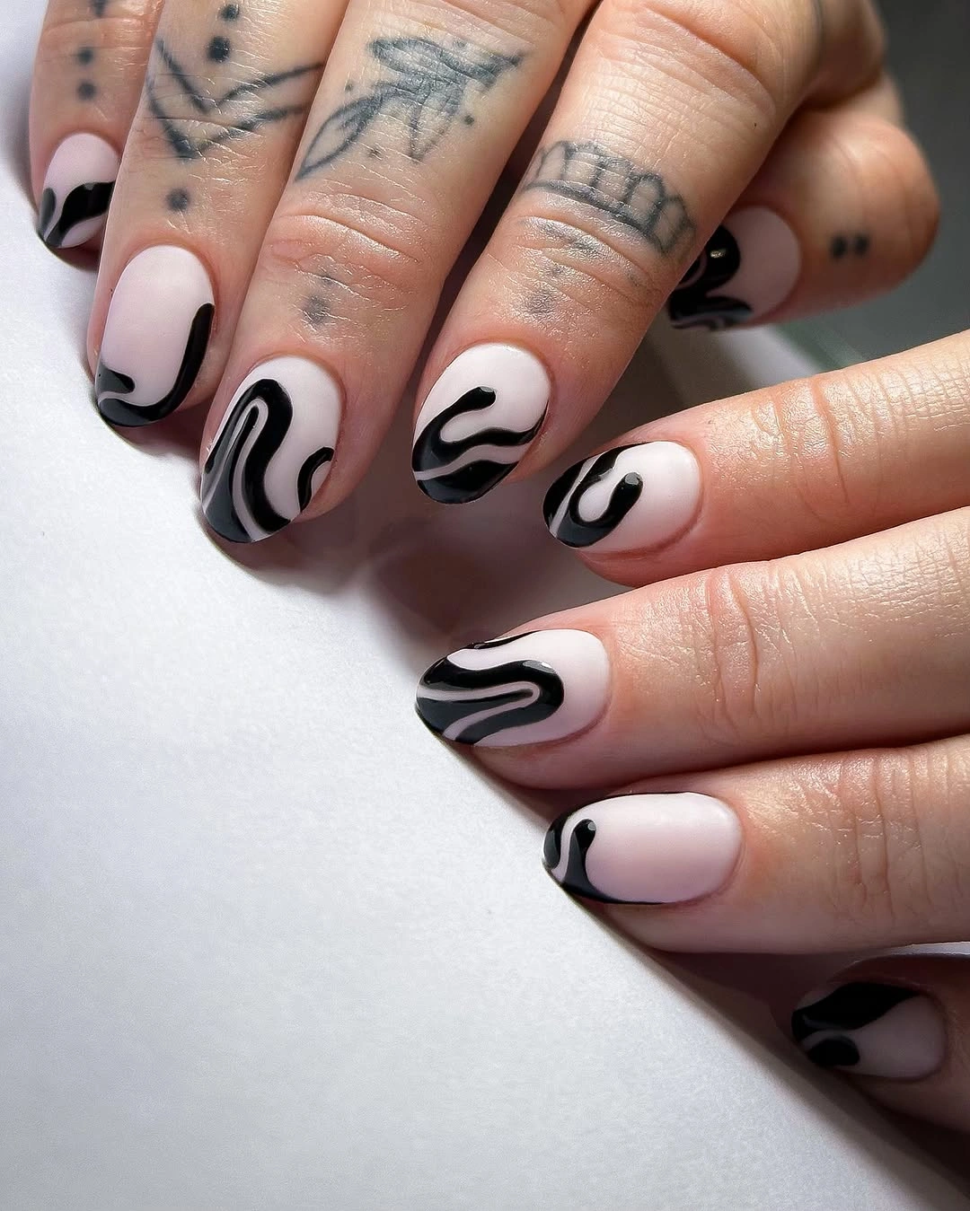 matte fall nails design 2026 Black Swirls on Soft Matte Nude