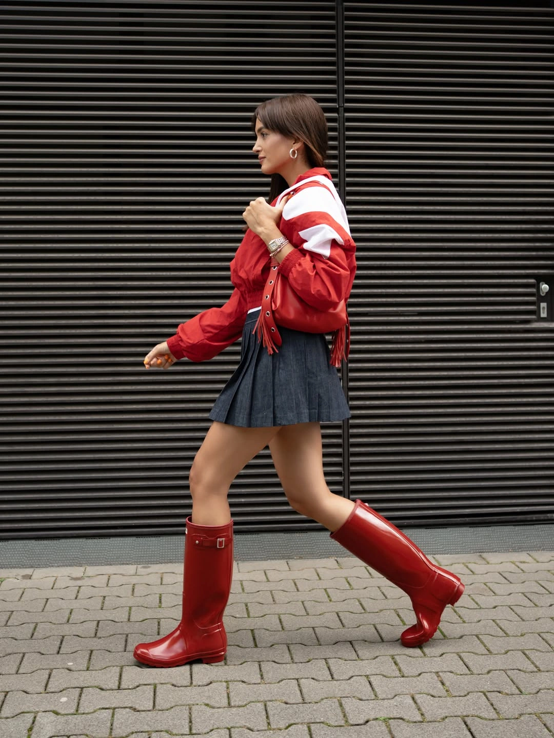 october fashion trends 2026 Red Rain Boots And A Pleated Mini