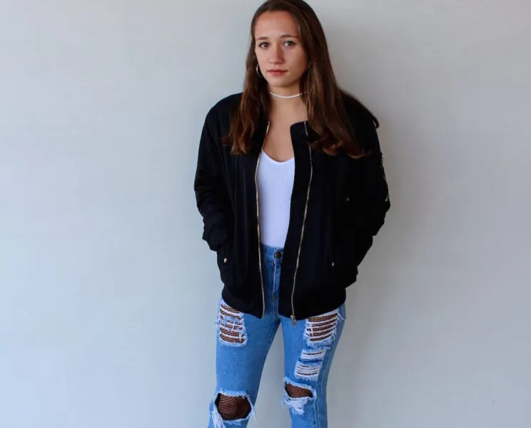 Bomber Jacket and Ripped Jeans with Fishnets for an Edgy Concert — Winter Concert Outfits