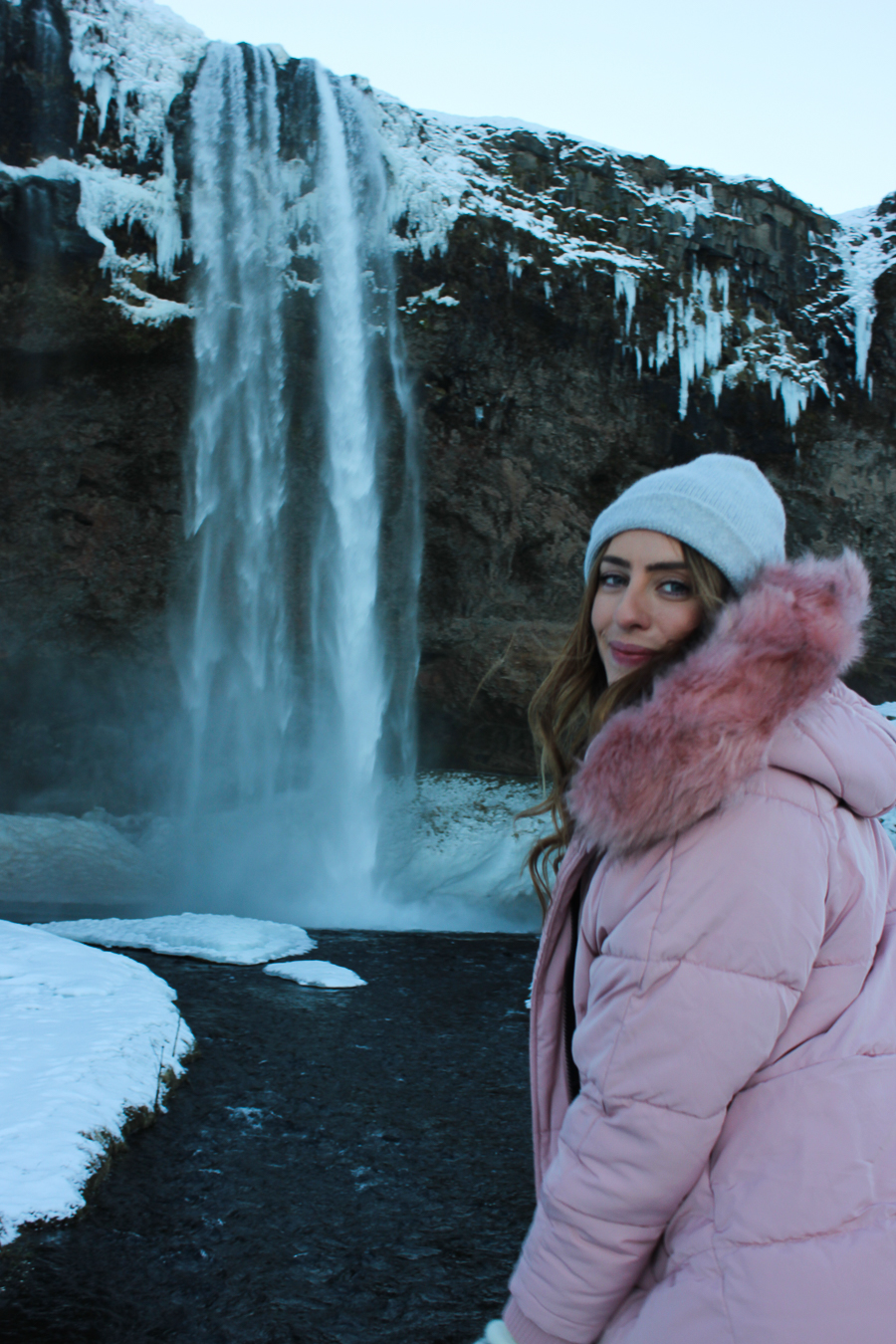 Vibrant Pink Puffer Coat for Snowy Landscapes — Iceland Winter Outfits