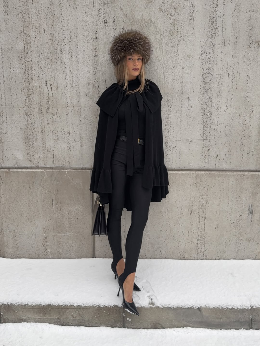 Black Cape with Ruffled Sleeves and Fur Hat for a Statement — Winter Date Night Outfits