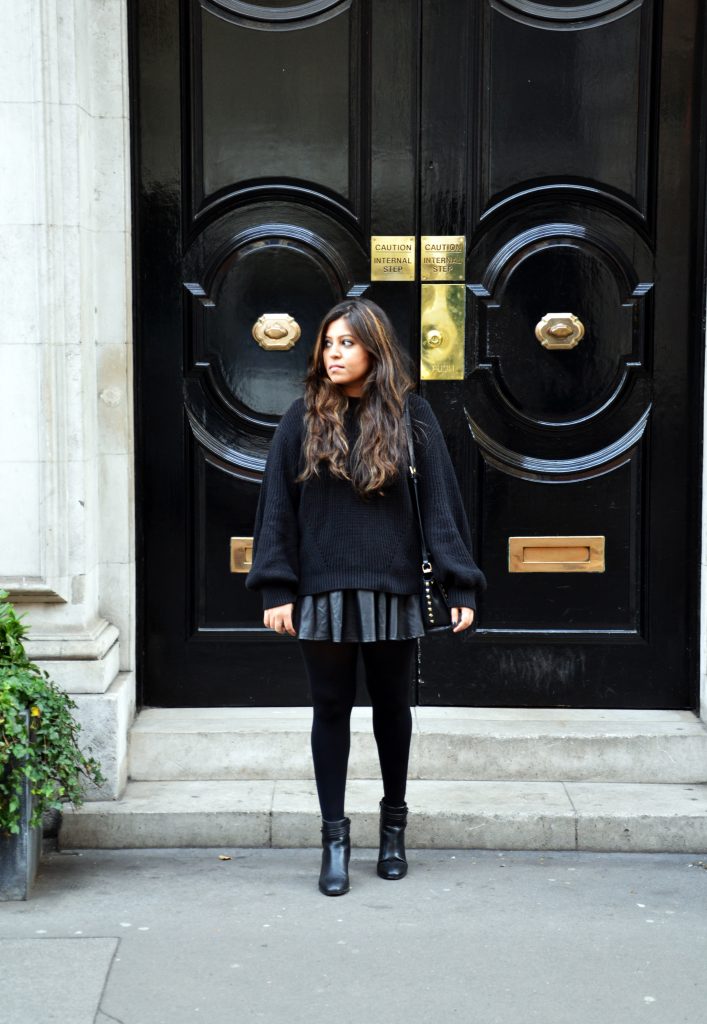 All-Black Oversized Sweater and Pleated Mini Skirt — Winter Skirt Outfits