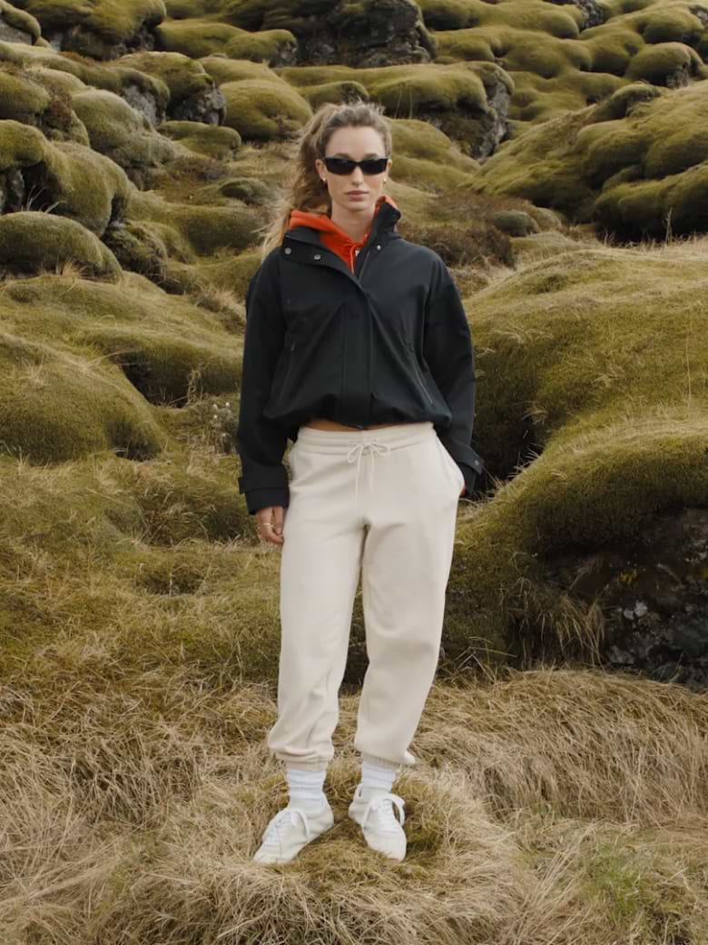 Layered Comfort: Black Jacket Over Orange Hoodie — Winter Workout Outfits