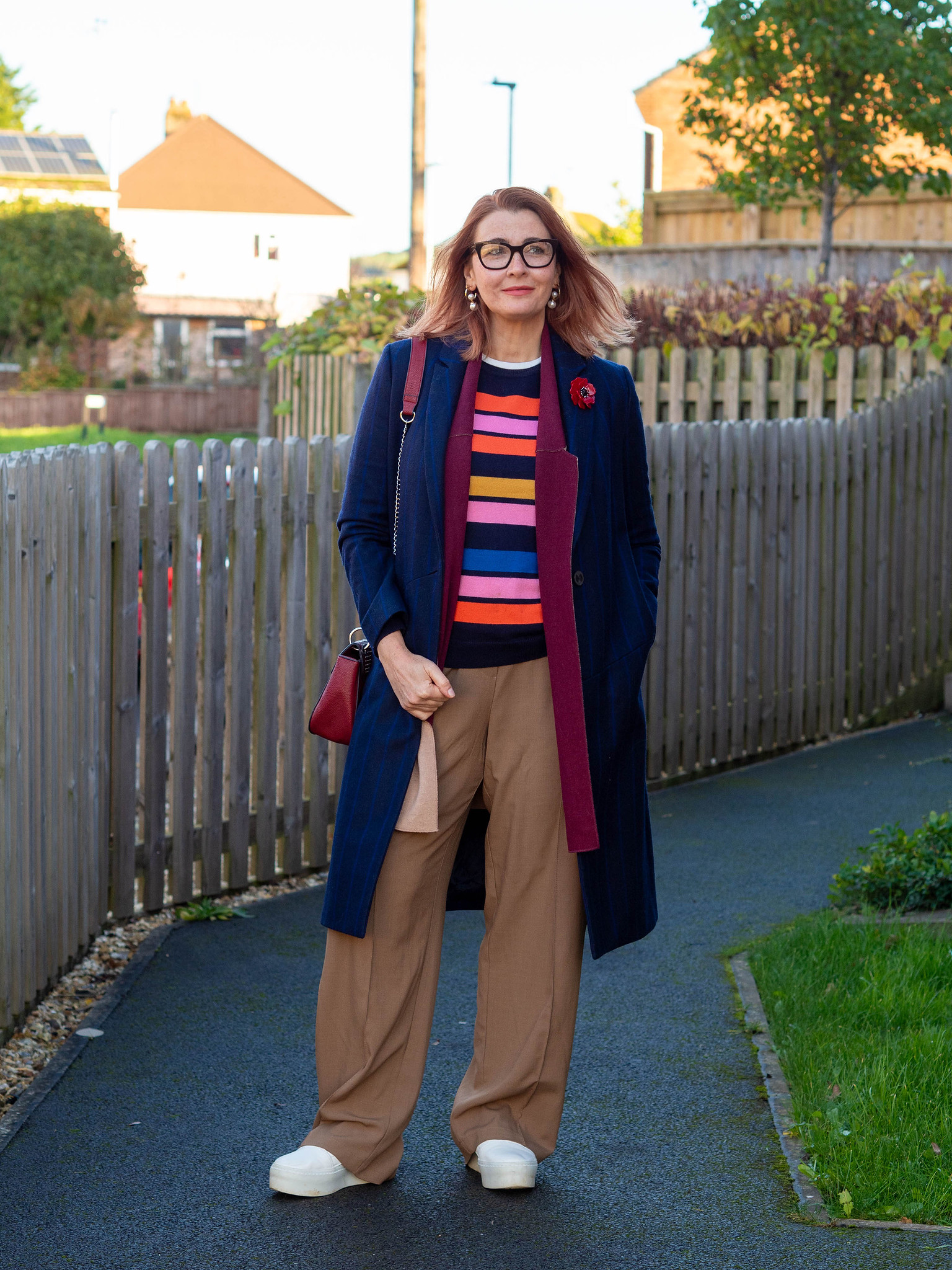 Striped Sweater Under Navy Coat with Wide-Leg Trousers for Travel Comfort — Winter Outfits for Women Over 50